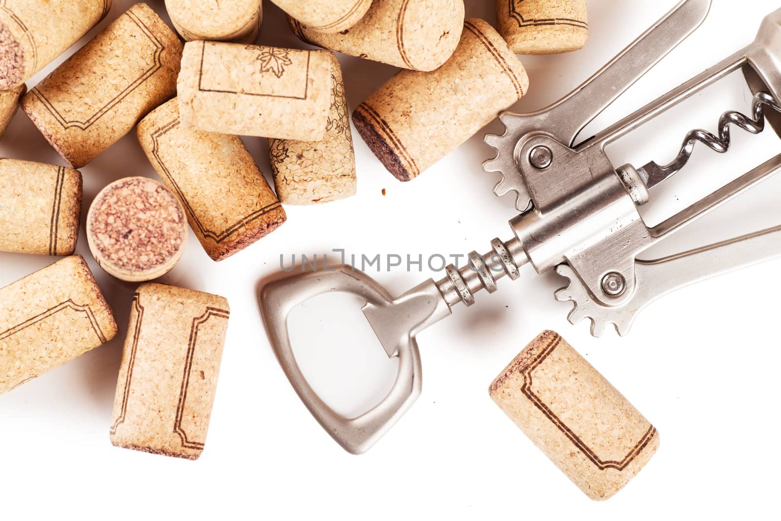 Corkscrew with extracted corks on white background