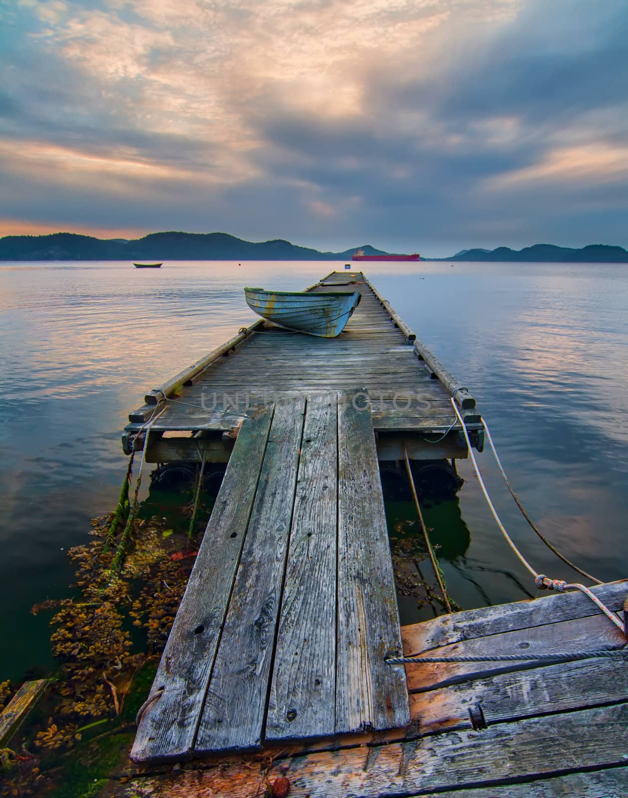 Rickety Island Dock with Mountains and Tankers in Distance by JamesWheeler