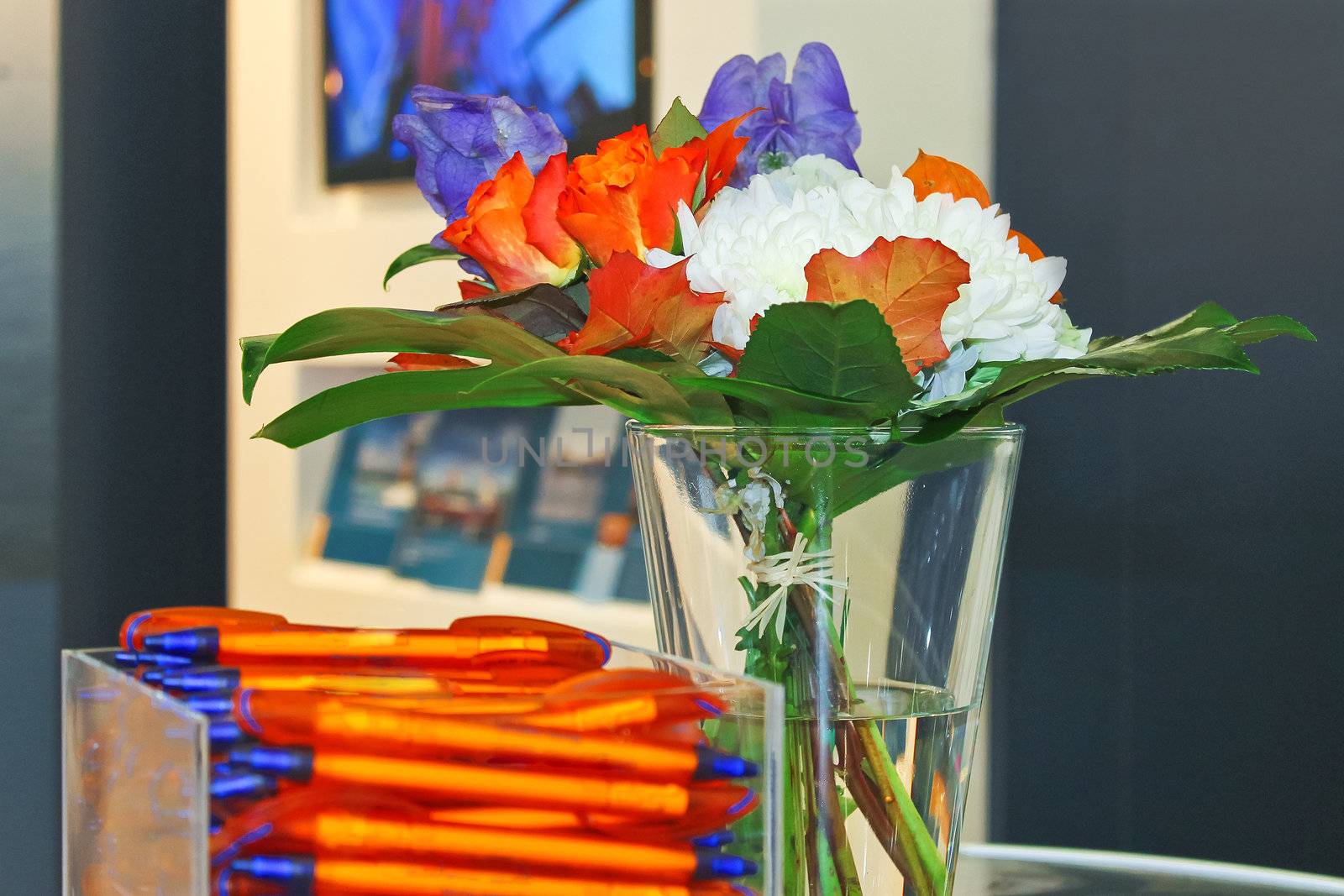 Gift pens and flowers in the interior of office by NickNick