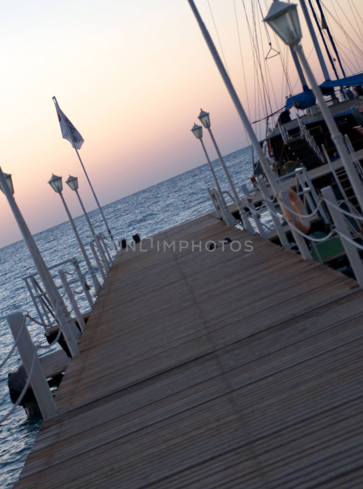 Pier with Lamps Early Morning on Dawn Sea background Outdoors