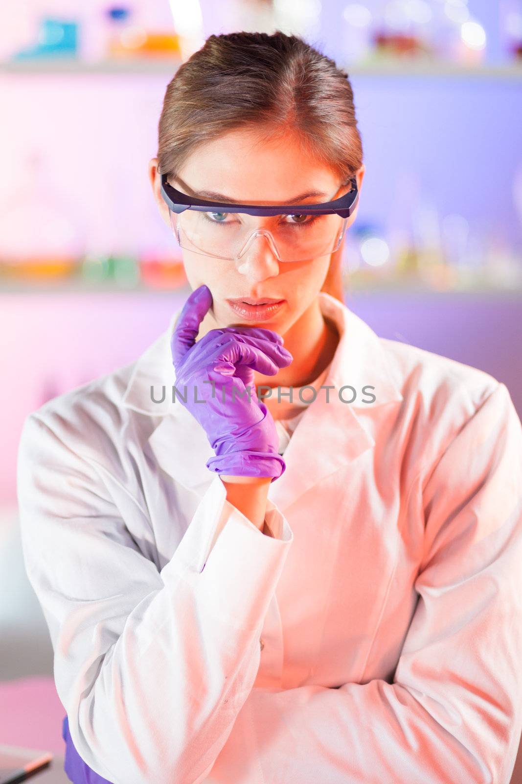 Portrait of an attractive, young, confident female health care professional in his working environment.