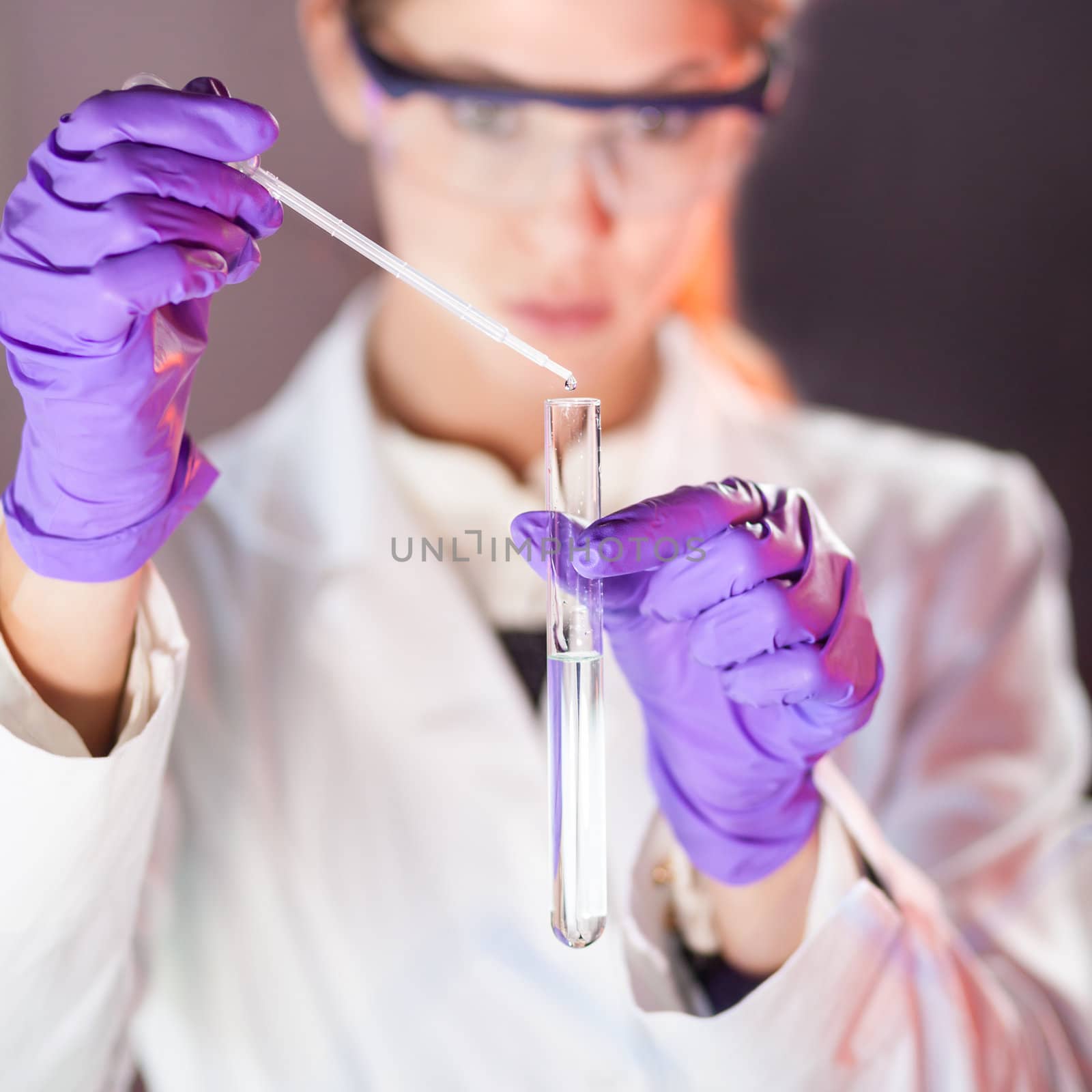 Young scientist pipetting. by kasto