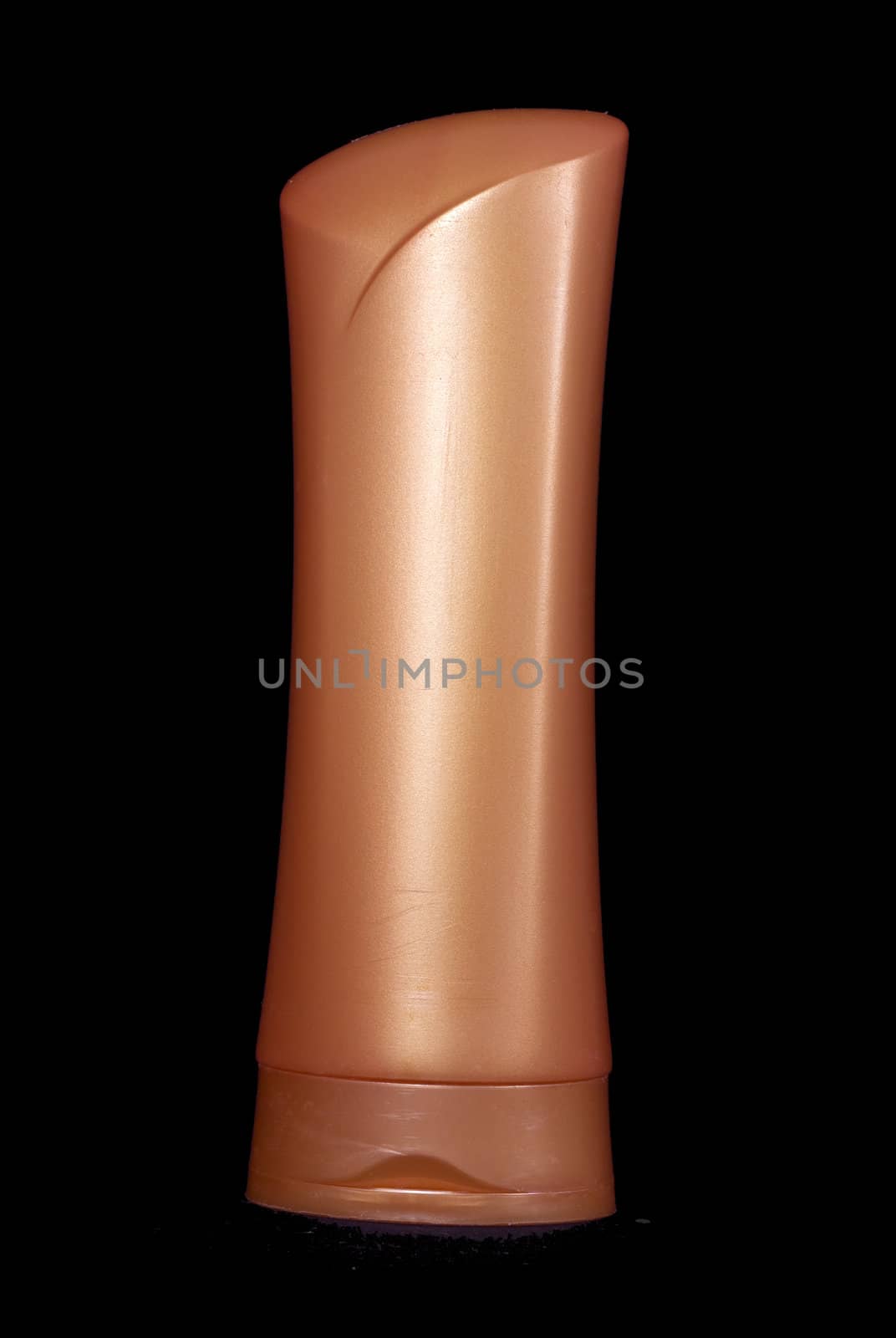 A big orange plastic shampoo bottle. Image isolated on black studio background.
