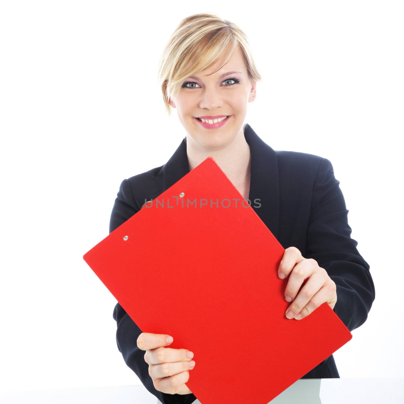 Efficient attractive young blonde businesswoman with a large red clipboard smiling attentively at the camera isolated on white