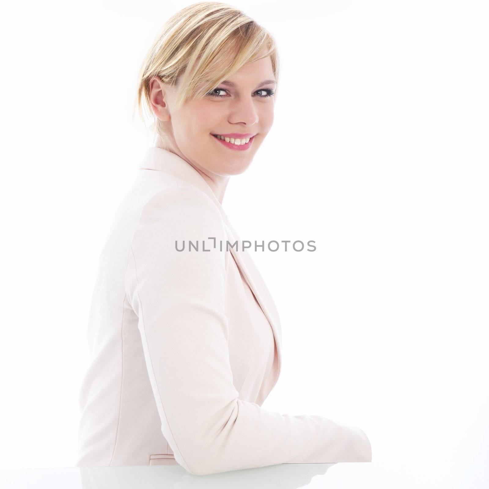 Side profile of beautiful young businesswoman smiling for the camera.