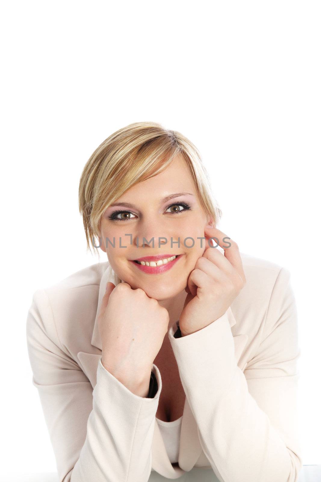 Confident professional woman in a stylish white jacket with a charming smile looking at the camera isolated on white