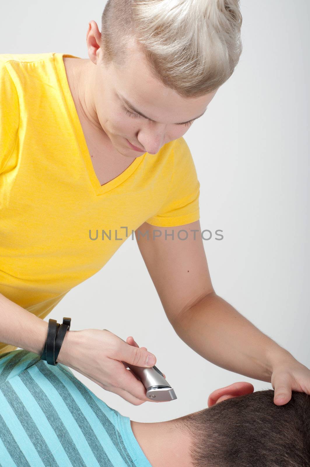 Hairdresser working with razor, studio shooting