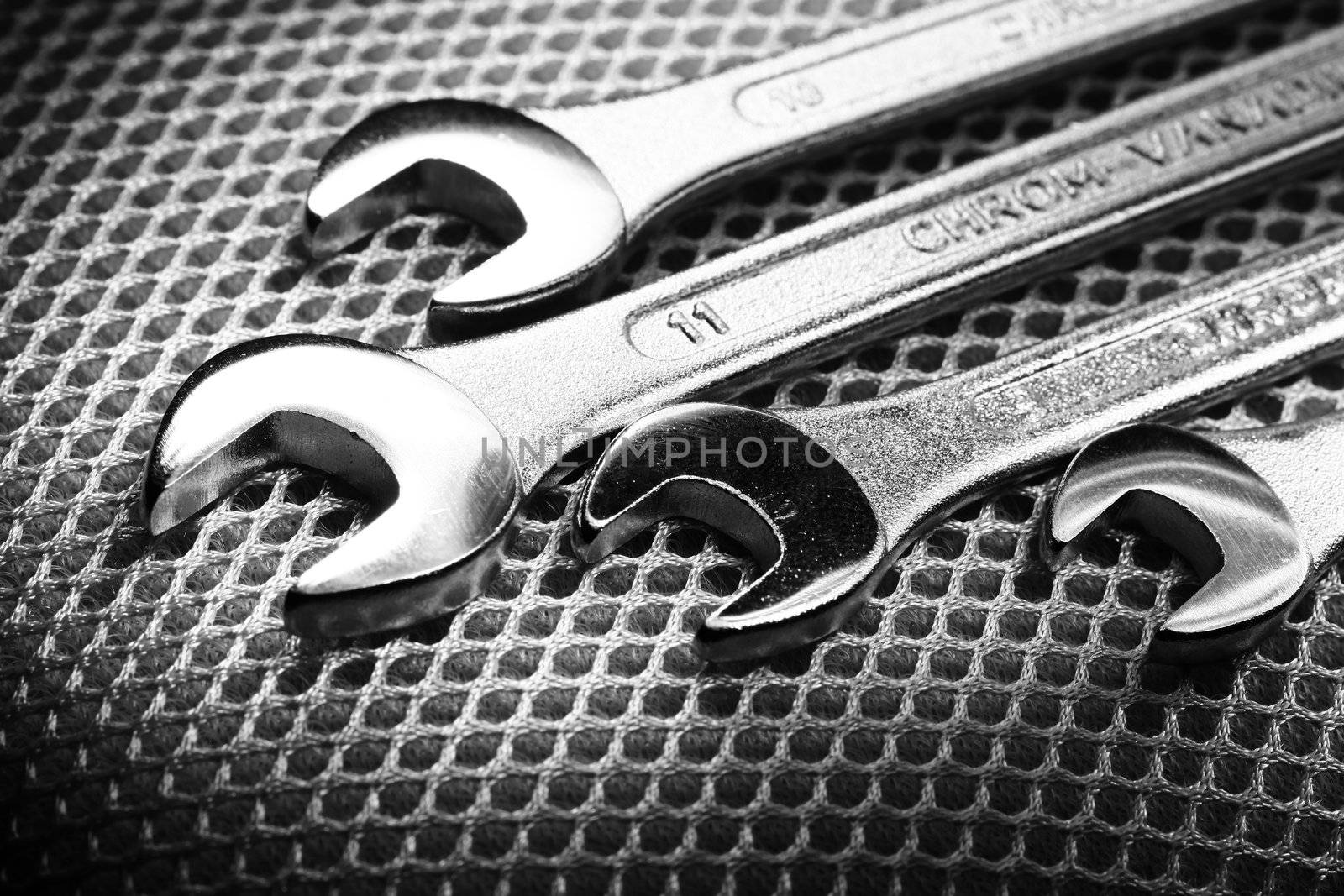 Closeup of iron spanners set over metal surface