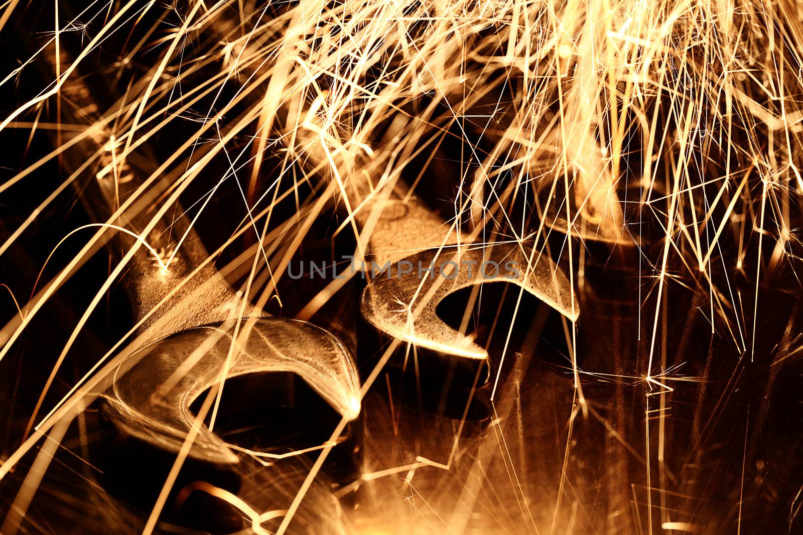 Closeup of iron spanners set and sparks light