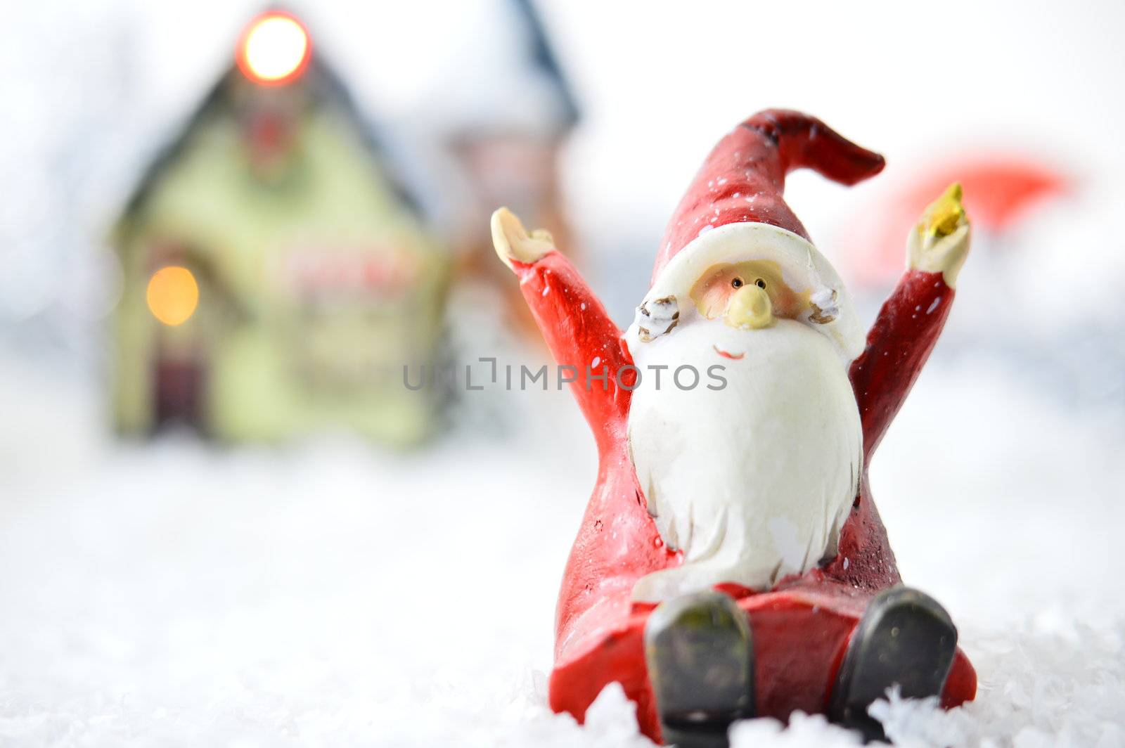 decorative Santa Clause in front of a house on white background
