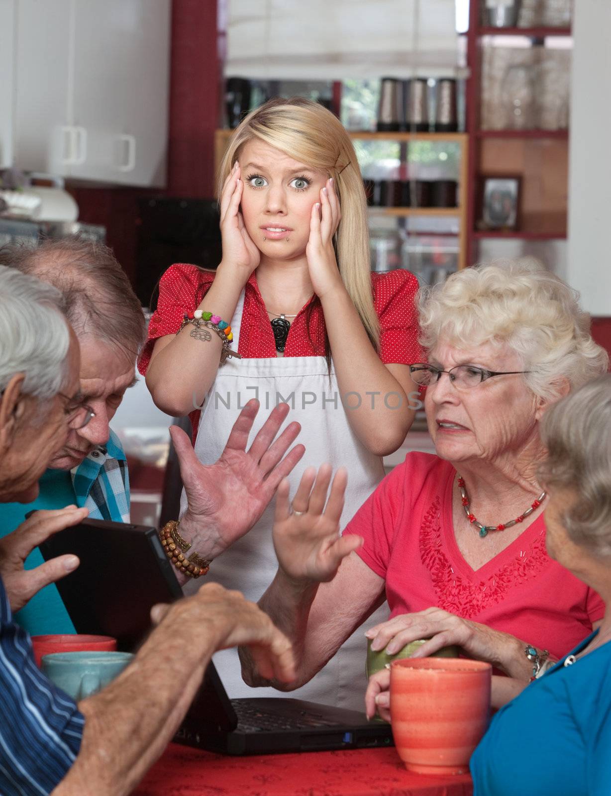 Bickering senior adults and young waitress in a cafe
