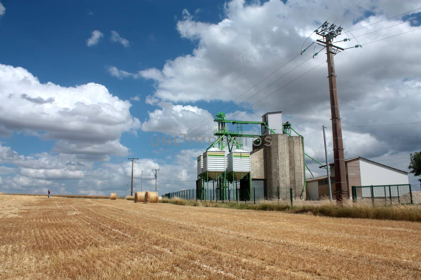 grain tower silo in French farmland on a cloudy day