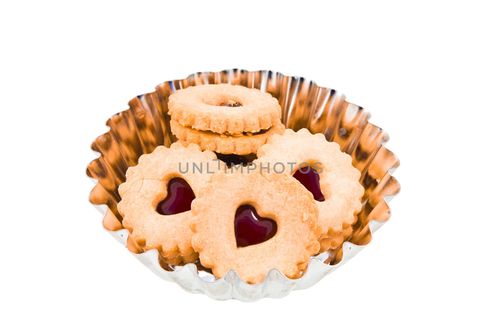 Round cookie with a heart of red jam on white background by huntz