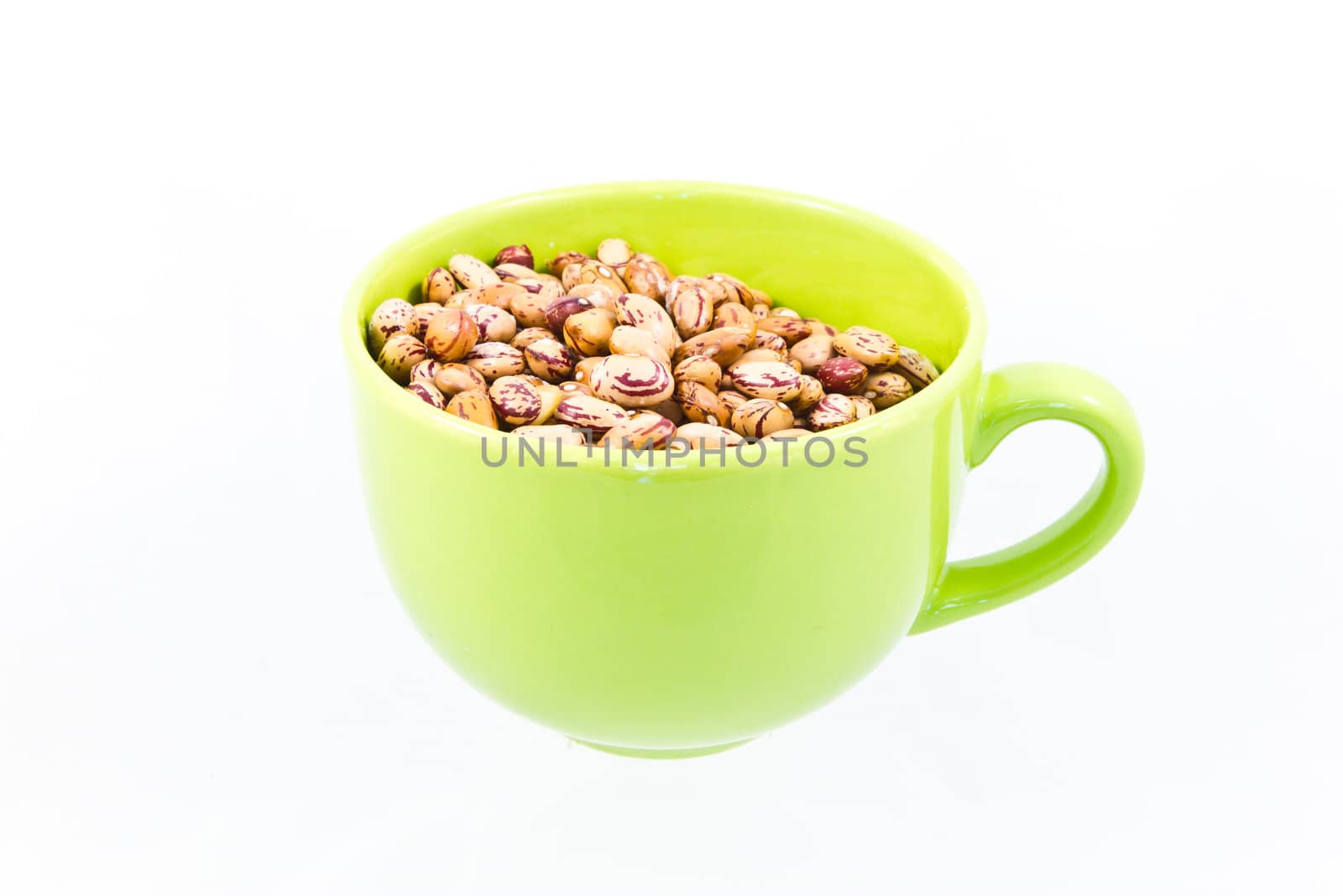 Many uncooked beans in cup