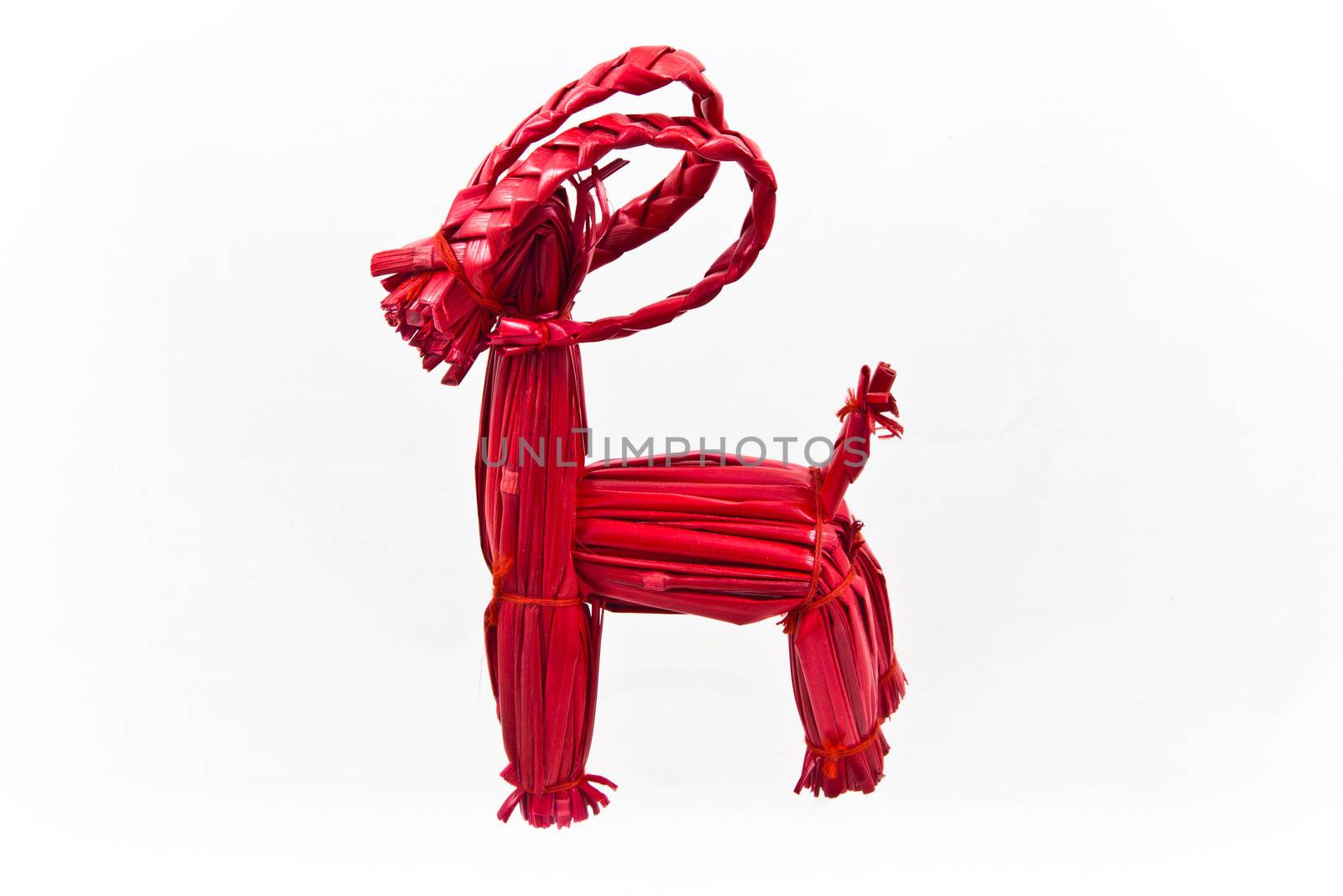 Red Swedish straw Yule Goat on a white background