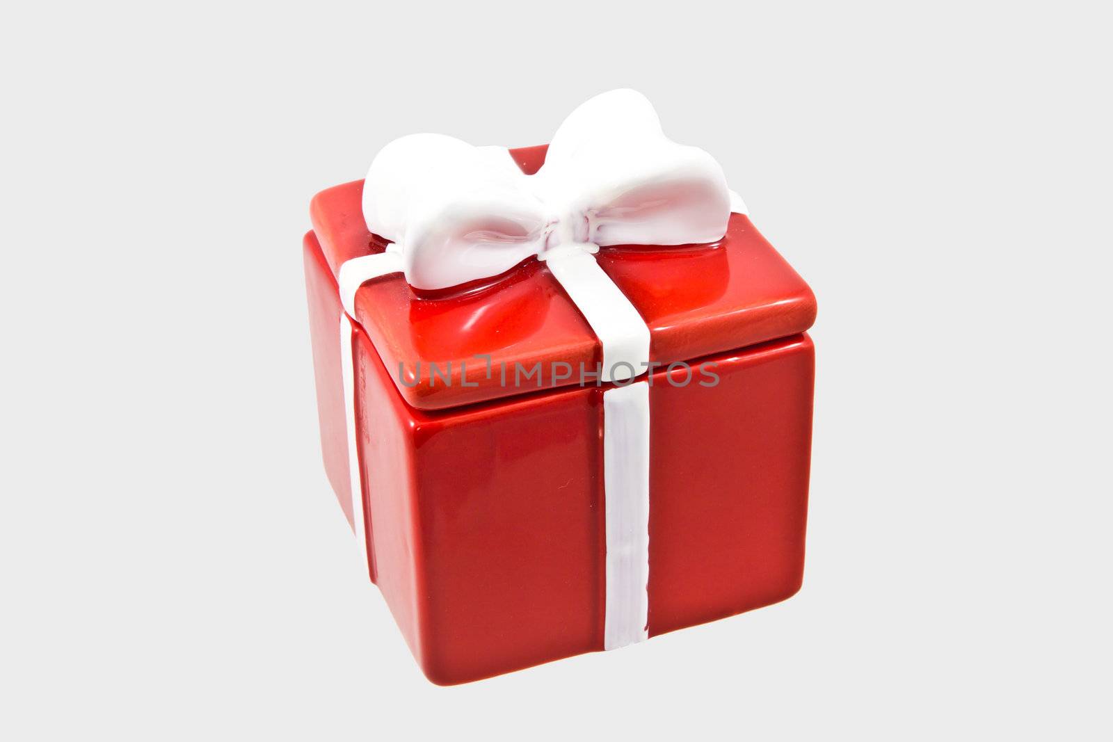 Single red gift box with white ribbon on gray background by huntz