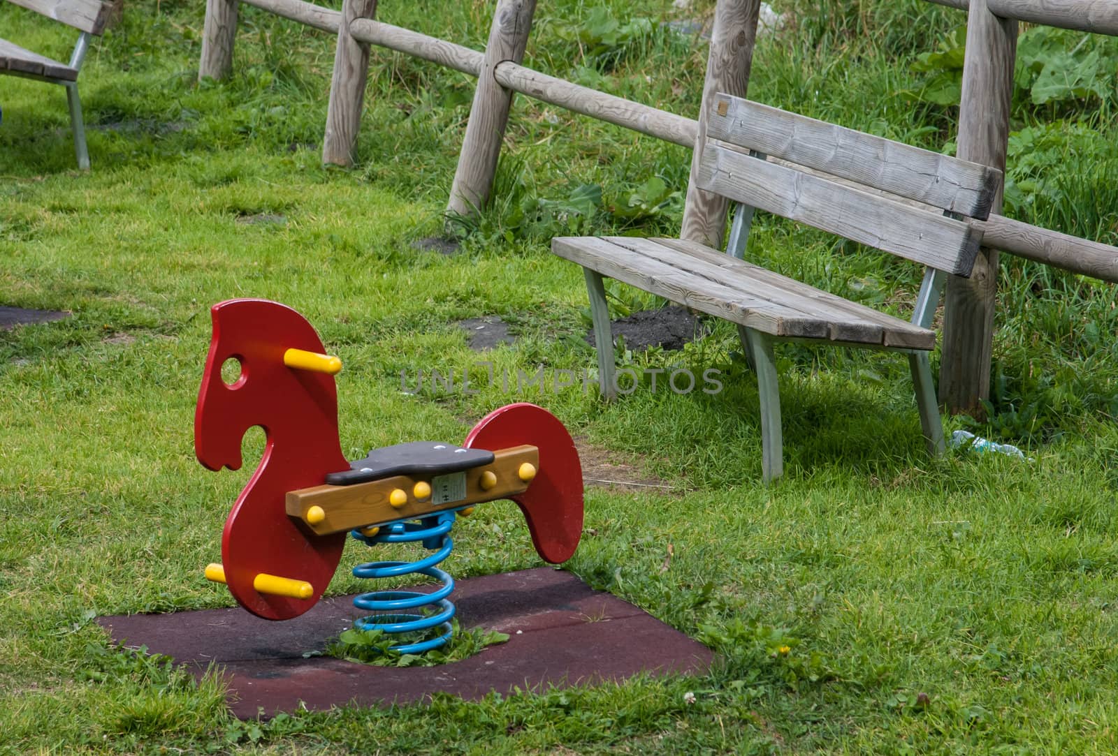 Child riding rocking horse in playground