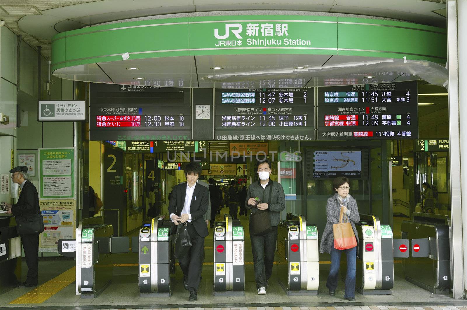 TOKYO, JAPAN -APRIL 22, 2011 : passengers go out from exit of famous Shinjuku station in Tokyo