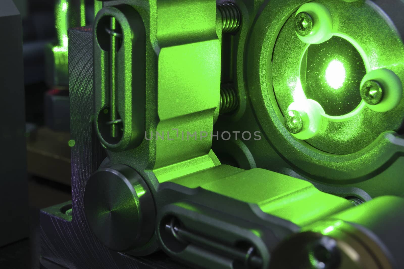 mirror reflection of powerful green laser light inside scientific system