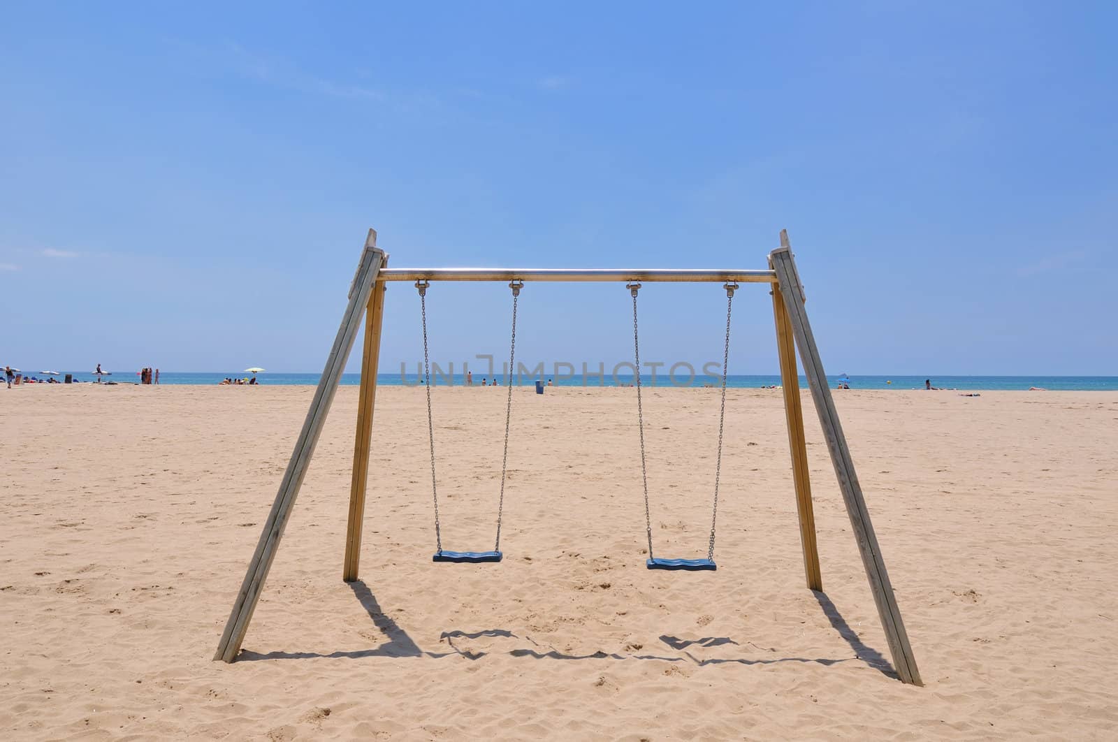 double beach swing over sand and blue sky background, Spain