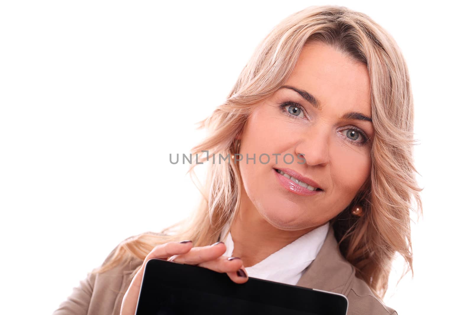 Portrait of mid aged woman in office suit smiling with laptop in hands