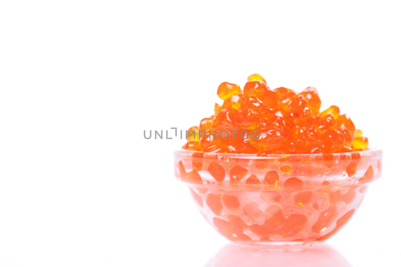Close up of red tasty caviar over white background