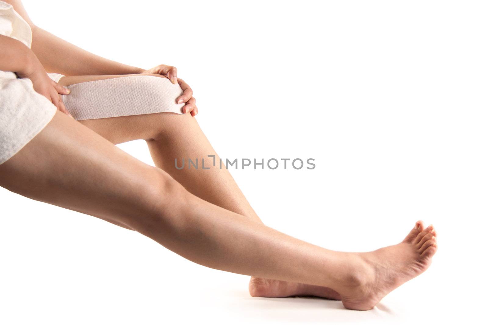 Beautiful feet of a female isolated over white doing waxing