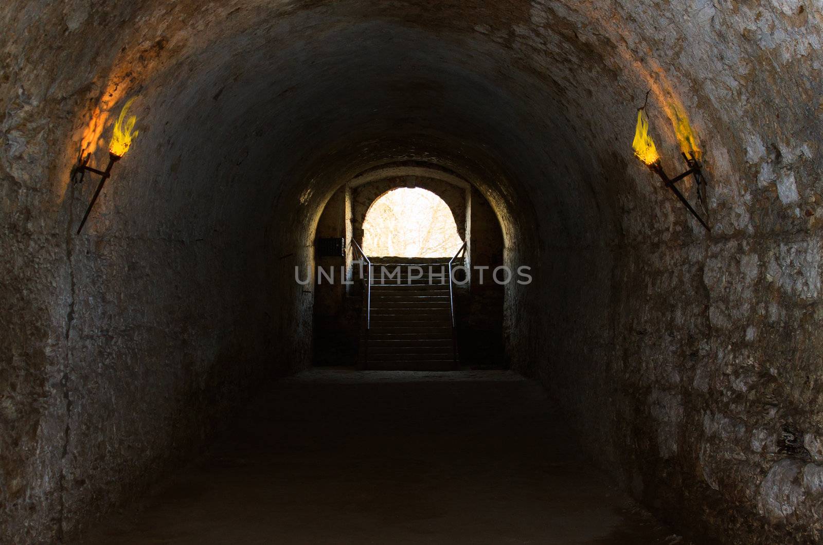 catacombs of the old castle illuminated burning torches