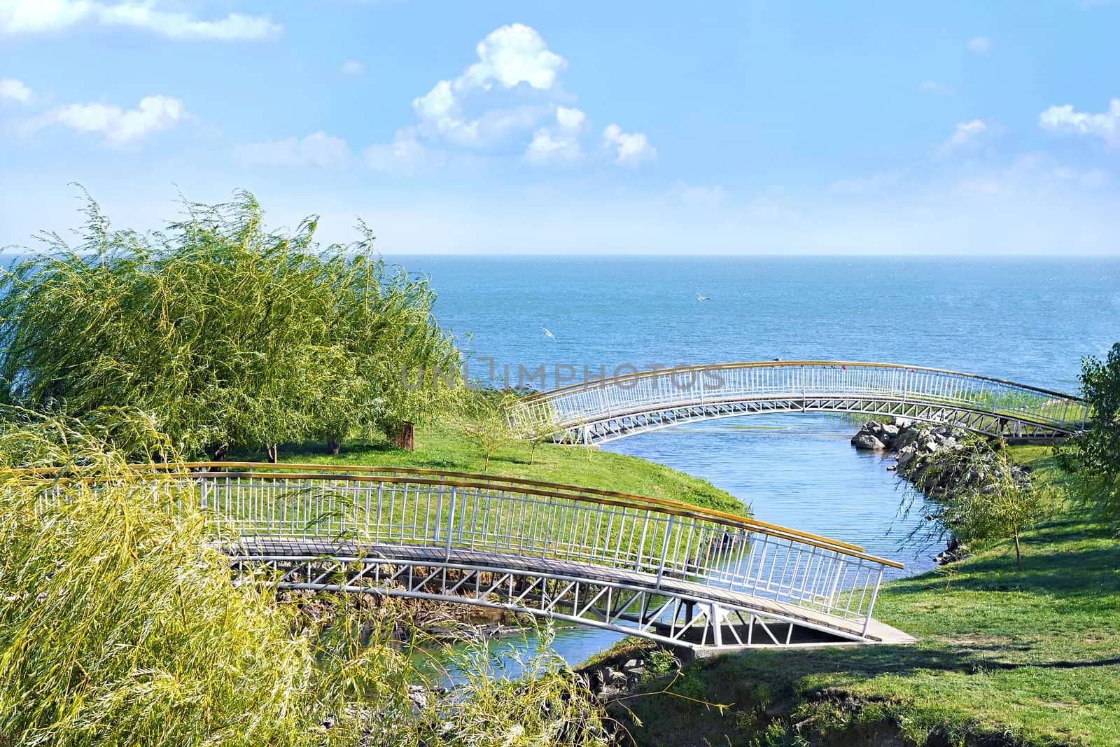 Pedestrian bridges across the river which flows into the sea