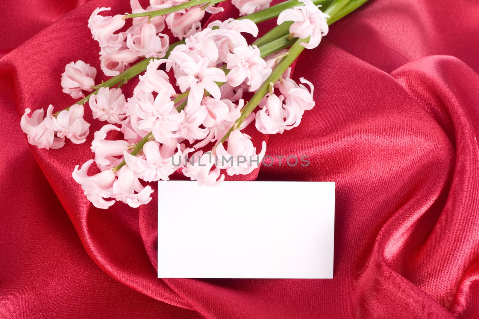 Bouquet of pink flowers on red silk