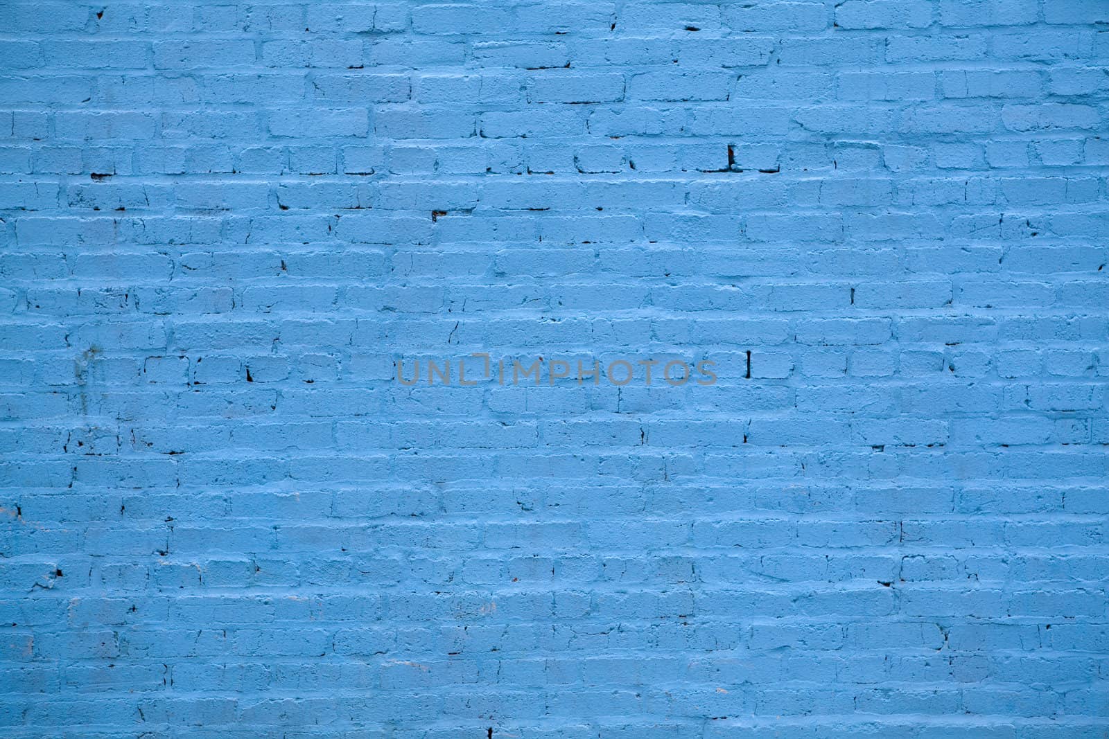 Background - building wall made of blue painted bricks.
