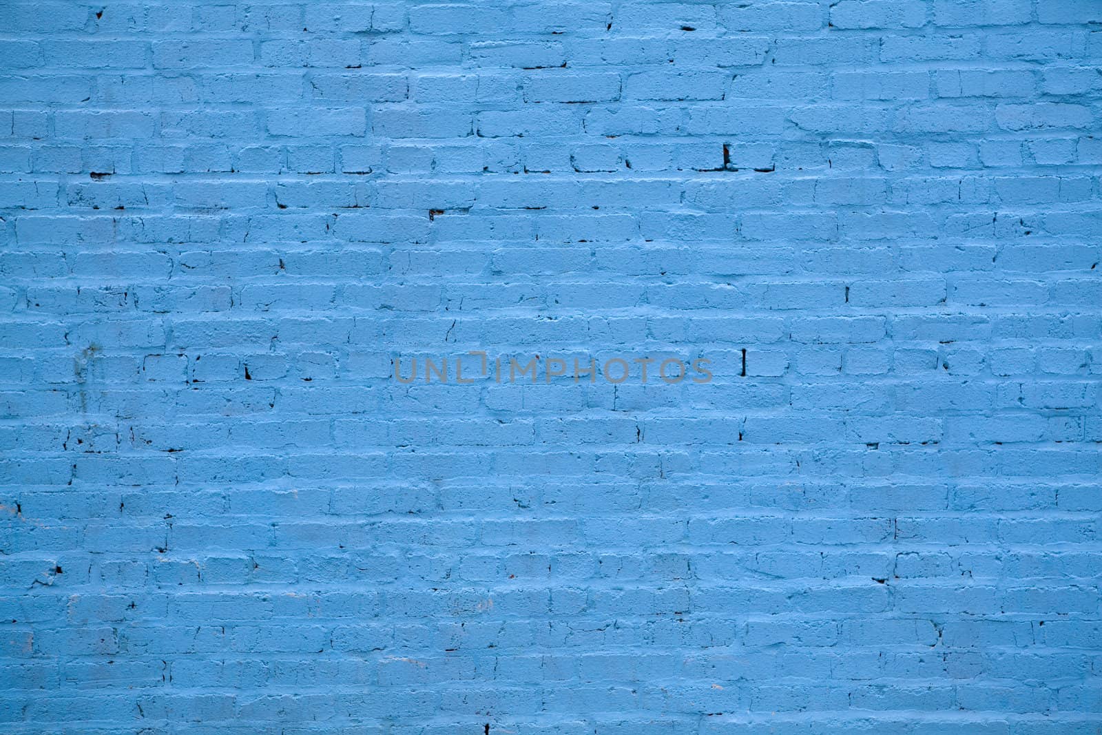 Background - building wall made of blue painted bricks.