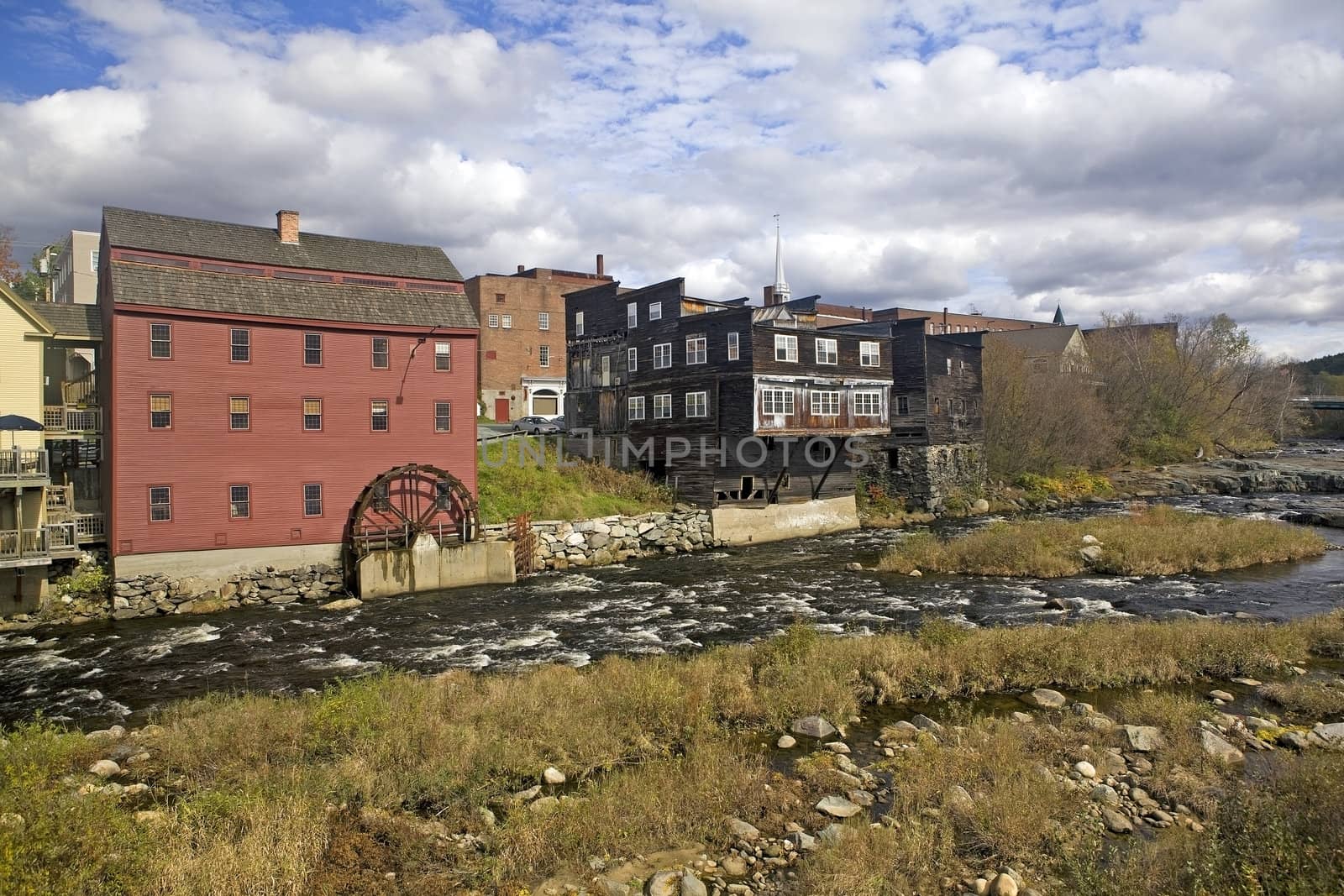 A restored vintage grain mill with water wheel on the Ammonoosuc River is still operating in Littleton, New Hampshire, USA. The mill is a popular tourist stop.