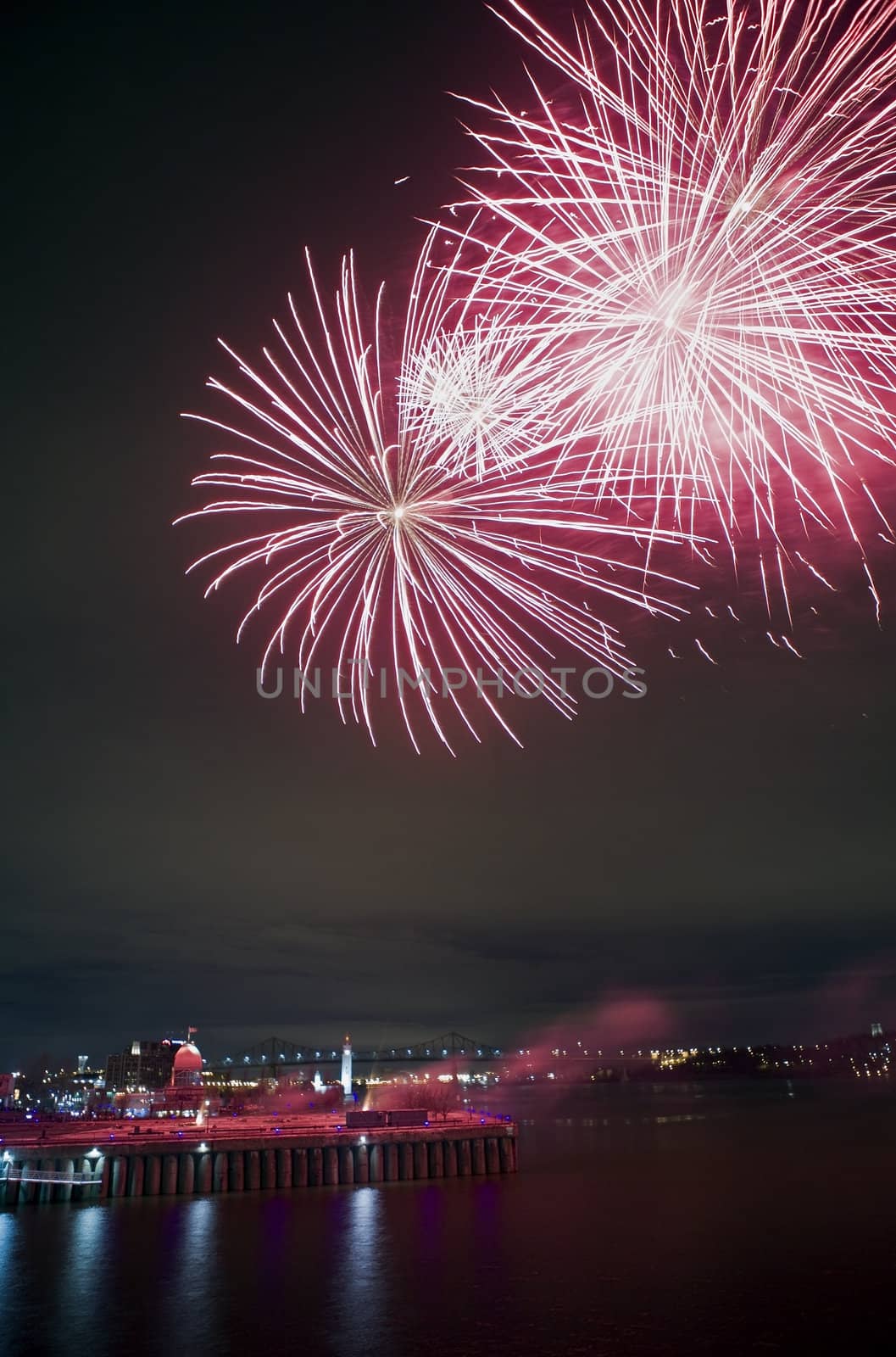 Montreal, Quebec, Canada - Night fireworks display. Jacques Cartier bridge visible in the distance.