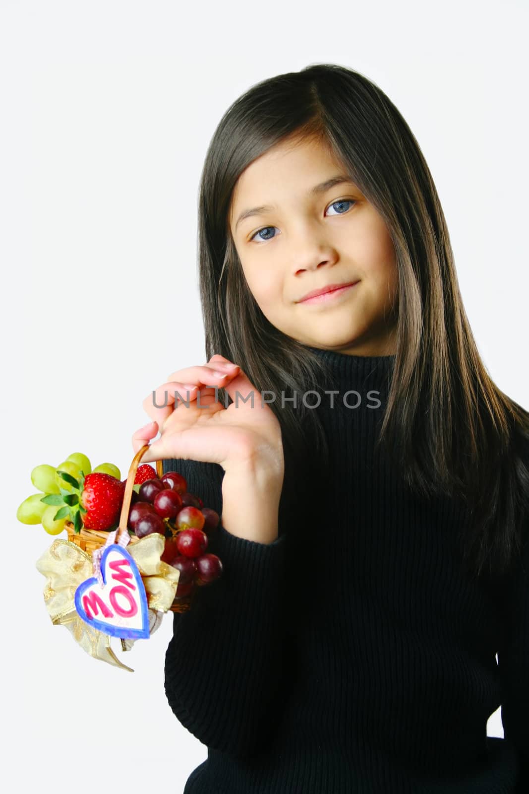Small girl holding a small basket of fruit for mom