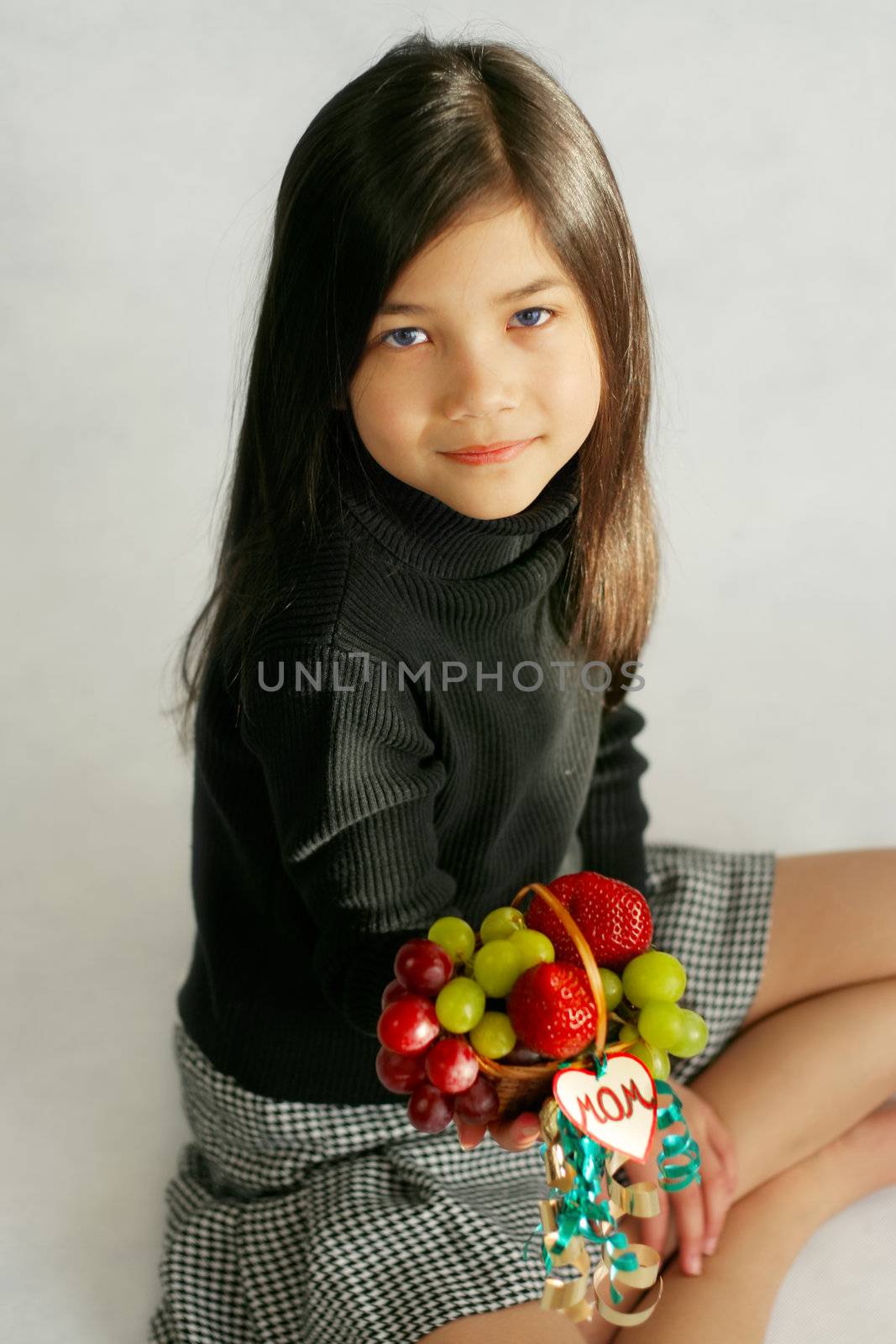 Child holding small fruit basket for mom by jarenwicklund