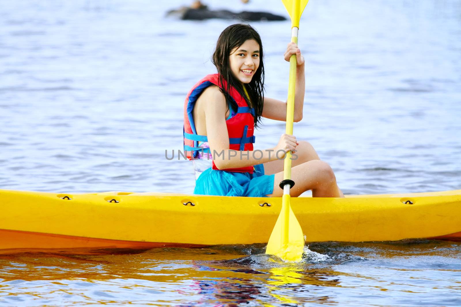 Teen girl in yellow kayak on lake by jarenwicklund