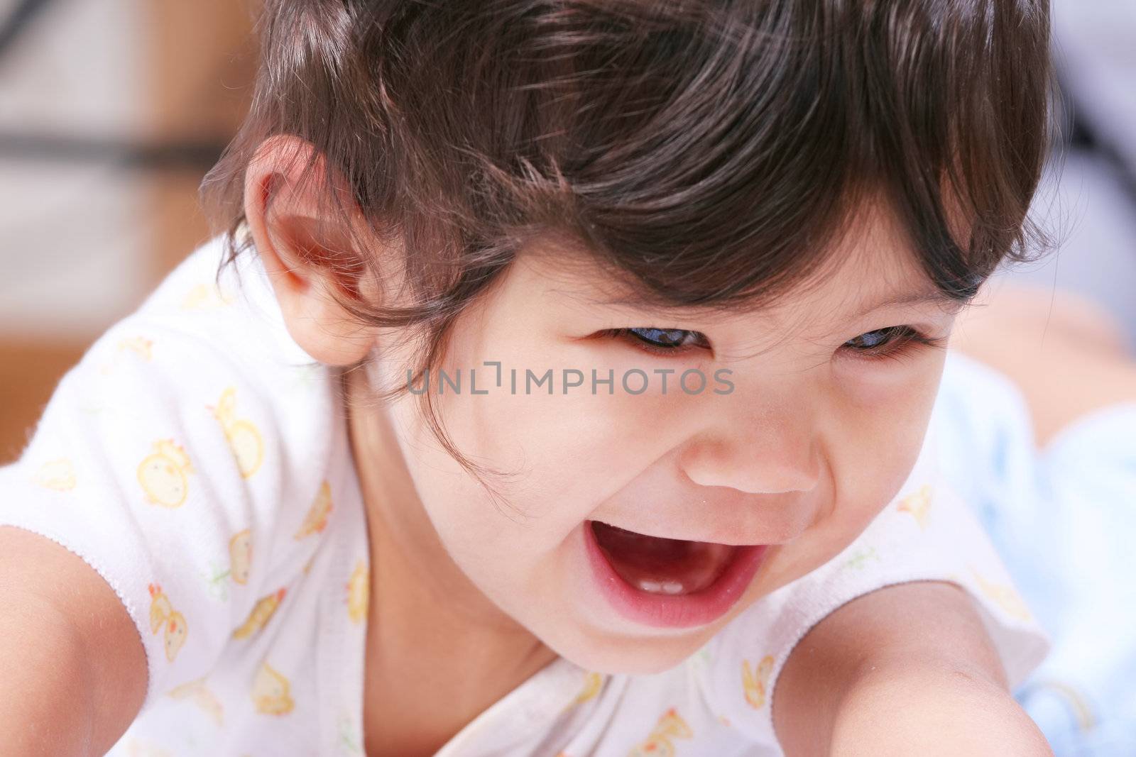 Happy smiling baby learning to crawl