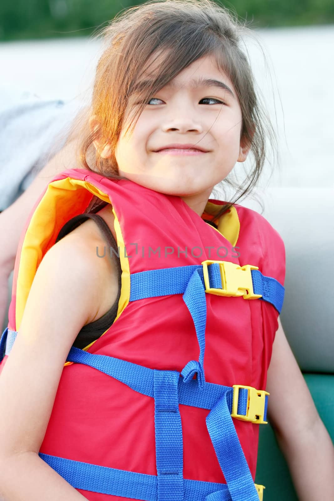 Little girl in life vest in boat