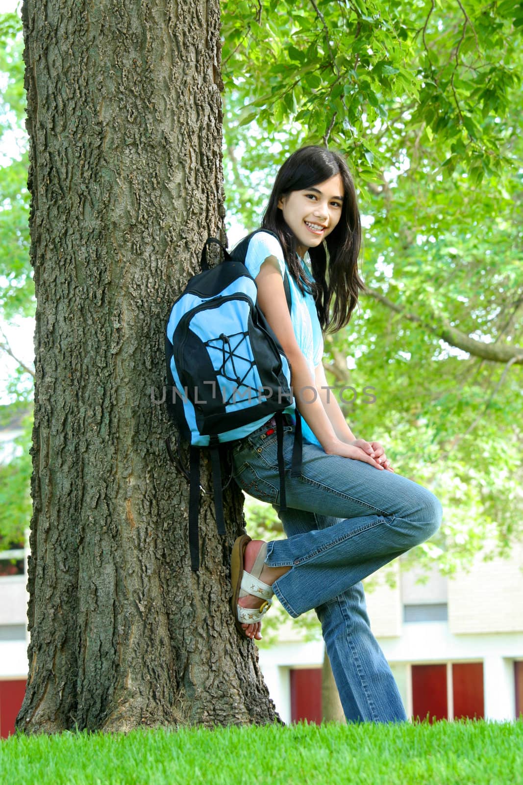 Young teen girl standing with backpack by tree, smiling. Part as by jarenwicklund