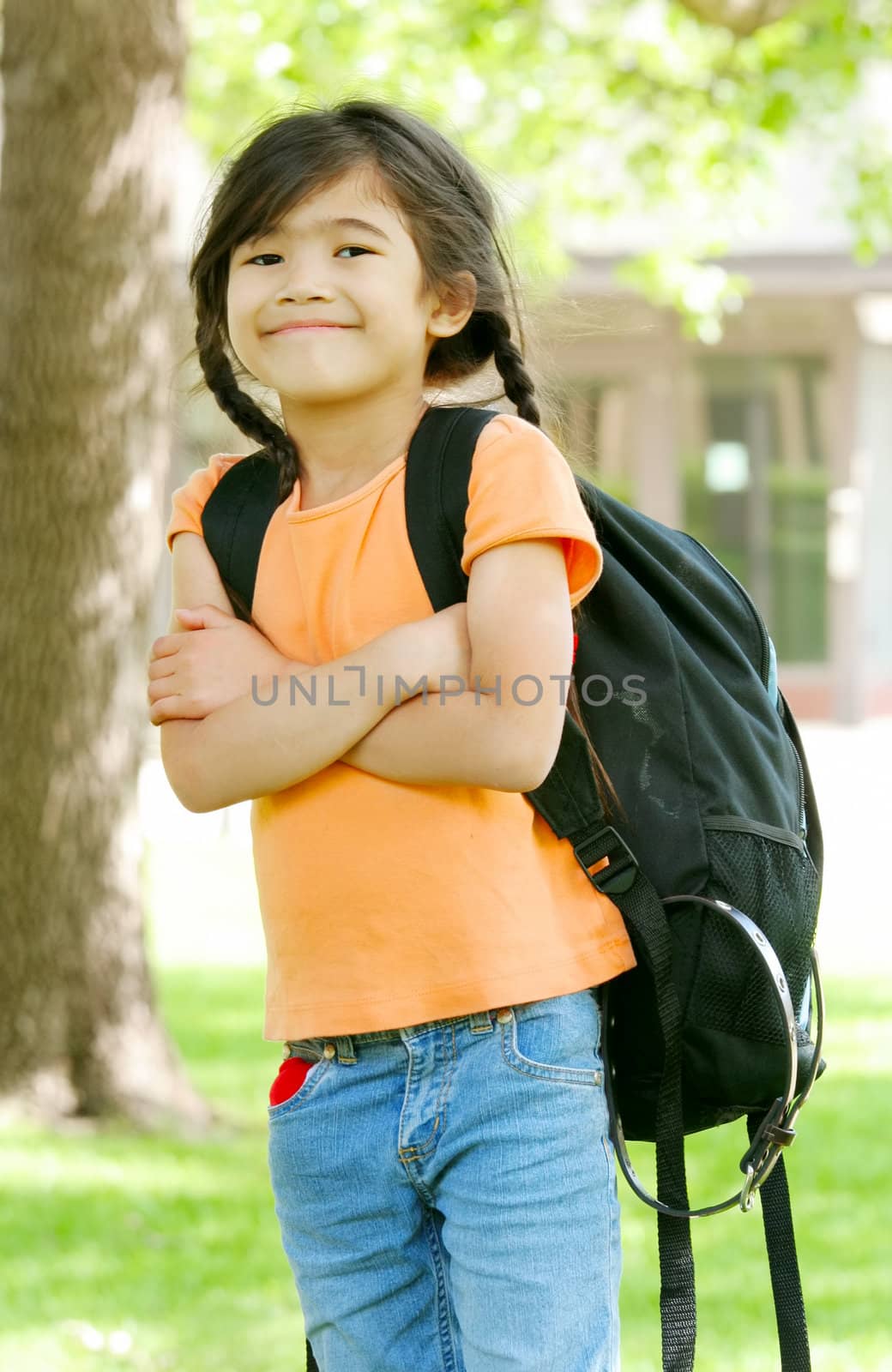 Cute biracial five year old with backpack at school by jarenwicklund