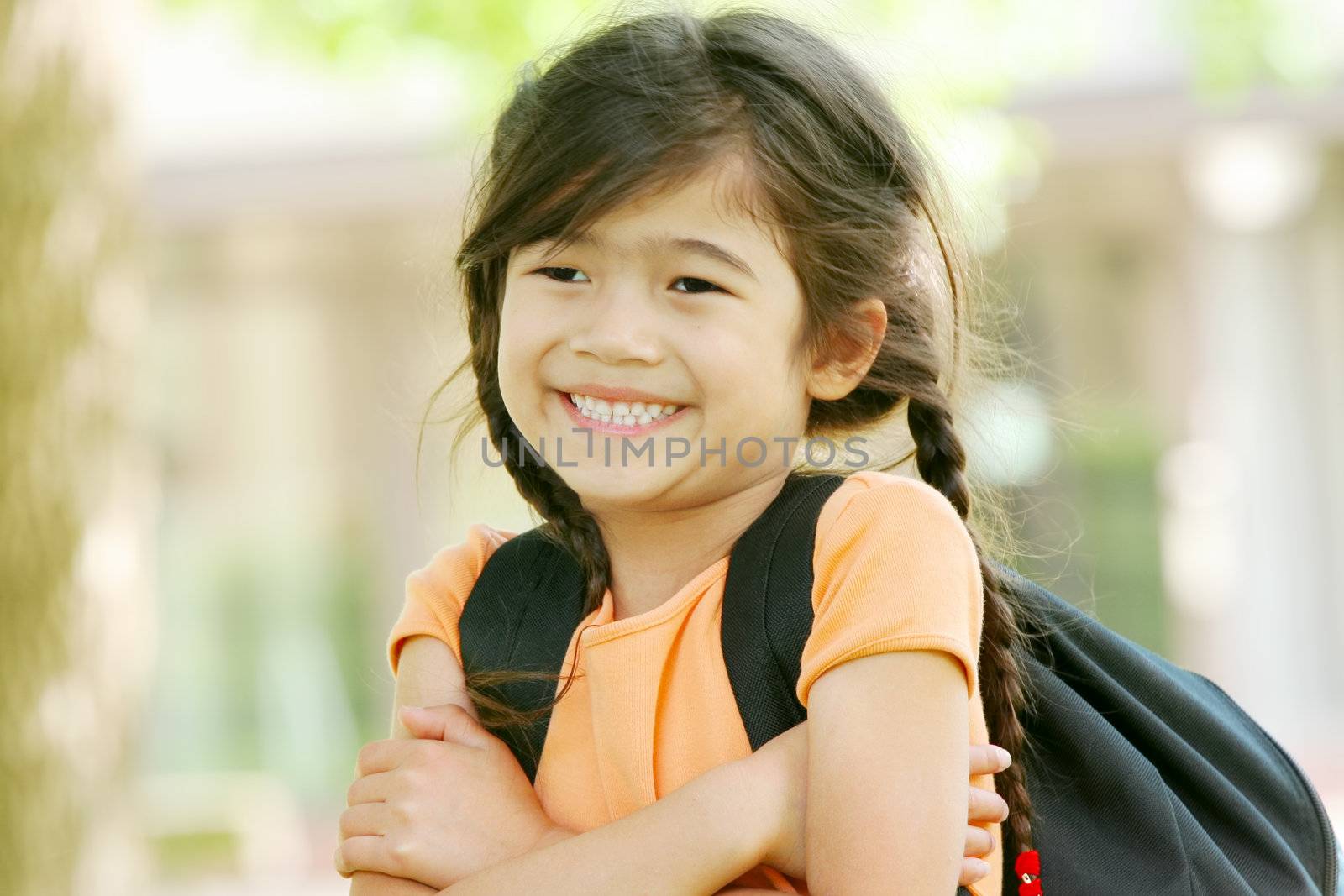 Cute biracial five year old with backpack at school by jarenwicklund