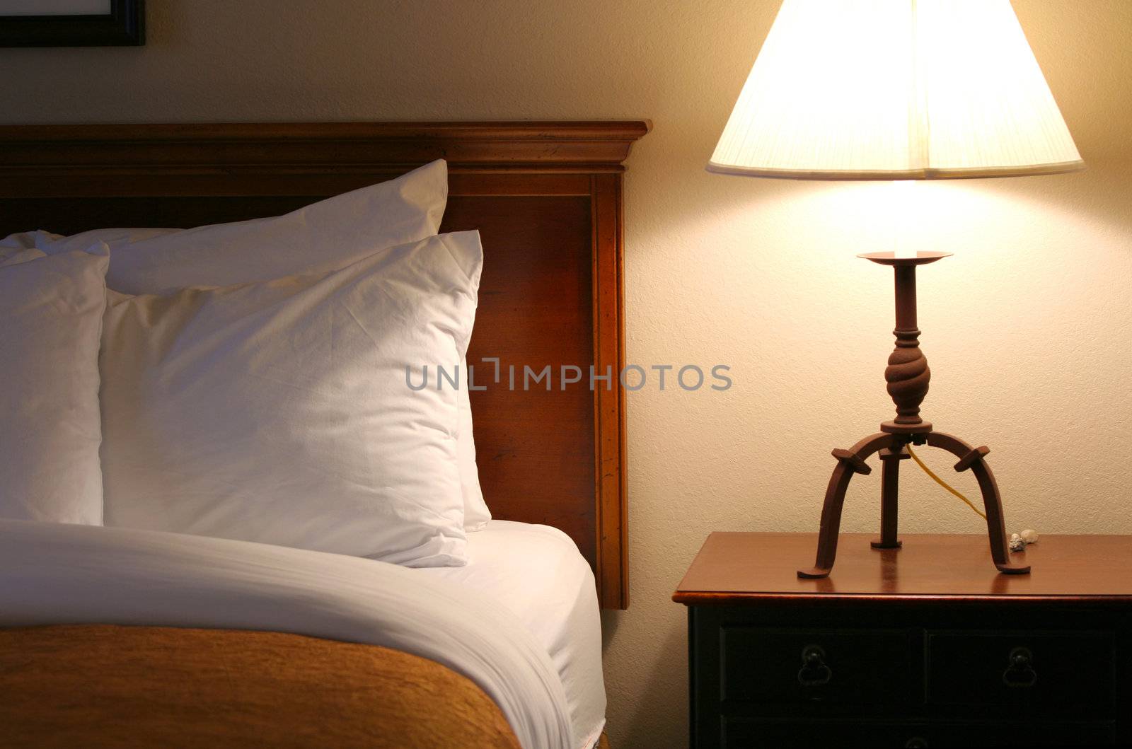 Comfortable, relaxing bed with lamp on side table