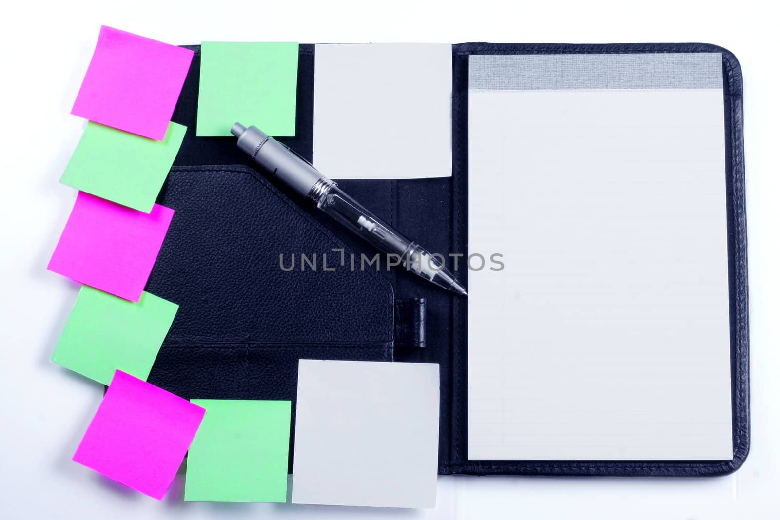 Black planner with sticky notes and pen
