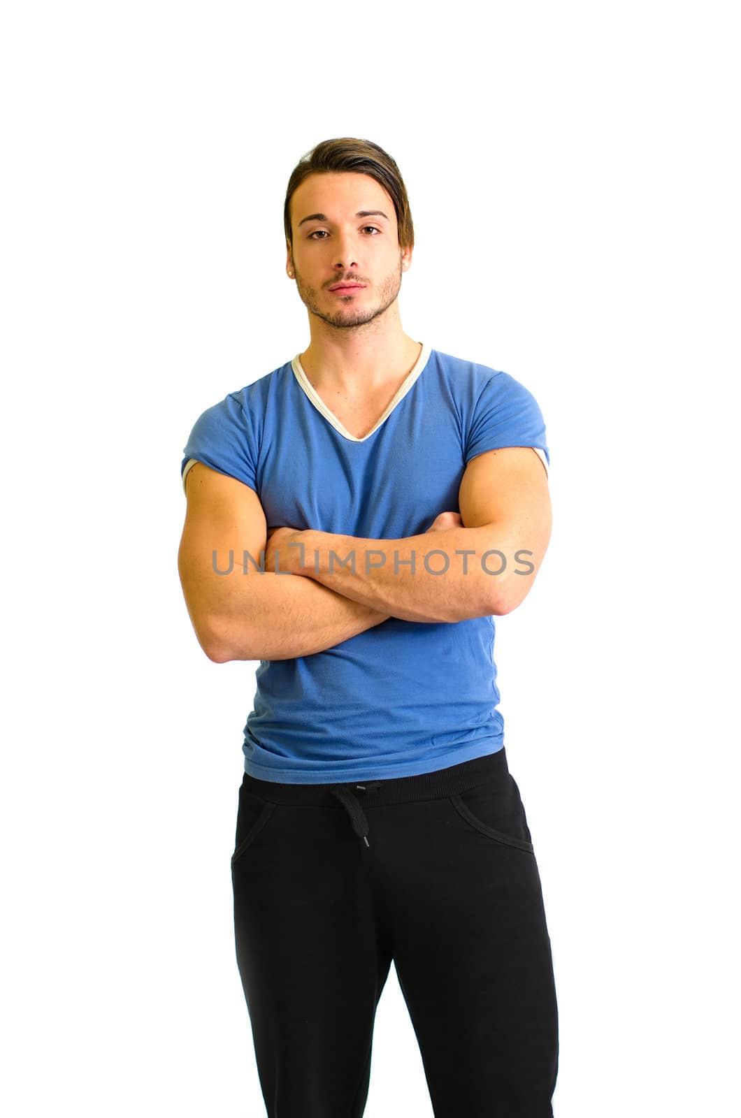 Handsome and athletic guy standing with arms crossed on his chest