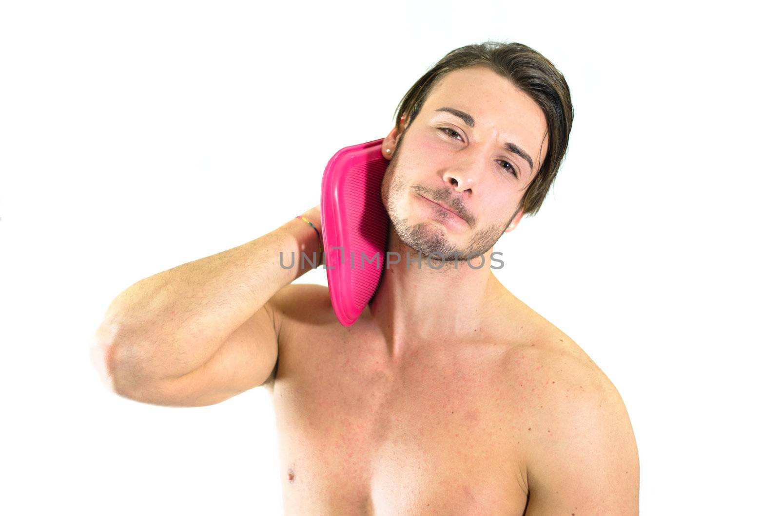 Muscular guy with neck ache, holding hot water bottle to relieve pain