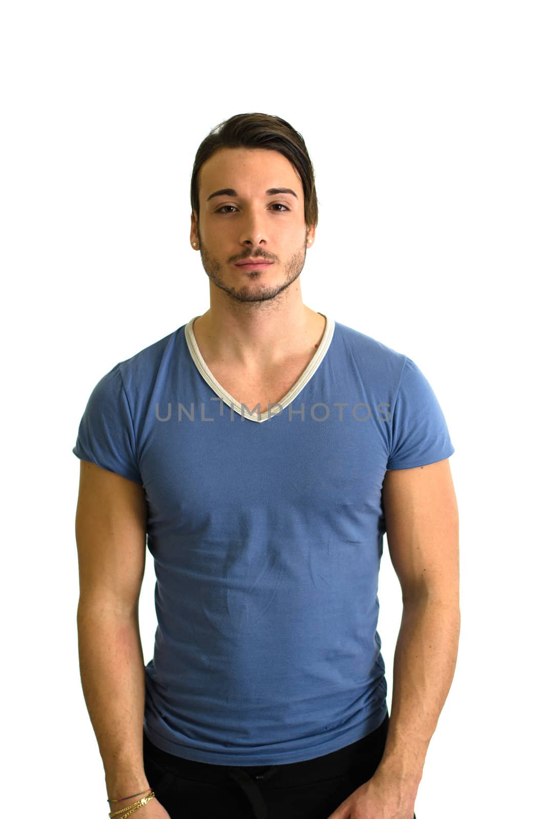 Attractive, muscular guy standing and looking in camera, isolated