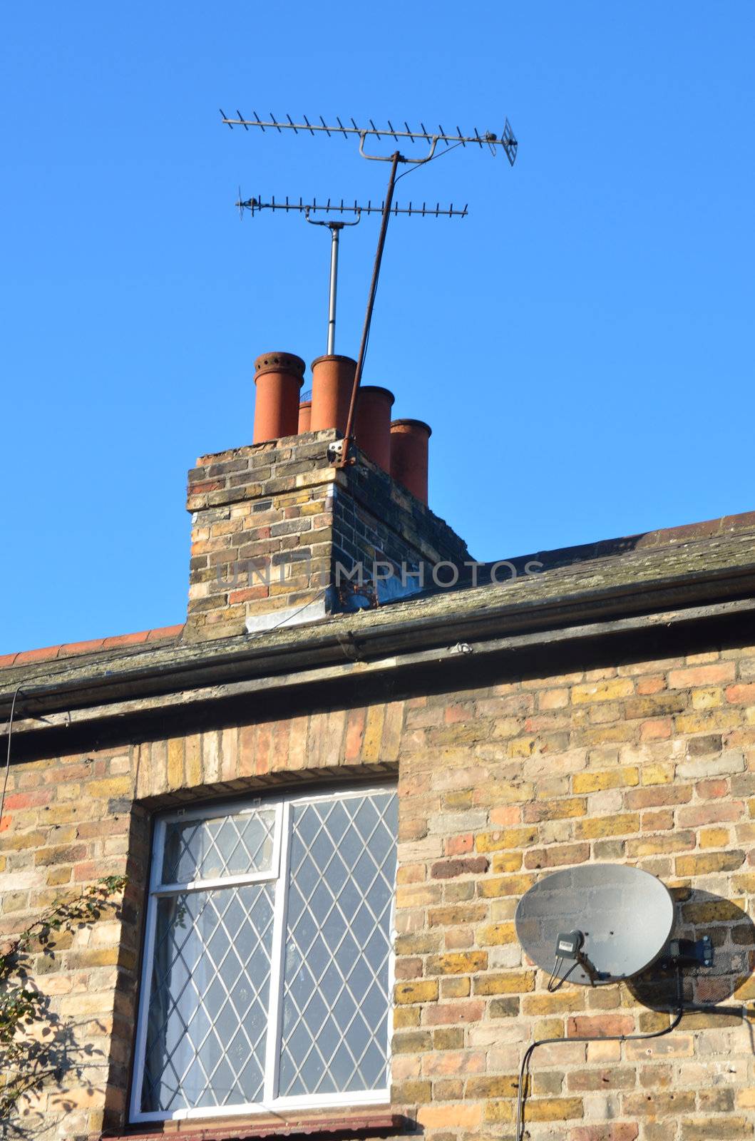 Aerial and satellite dish on house