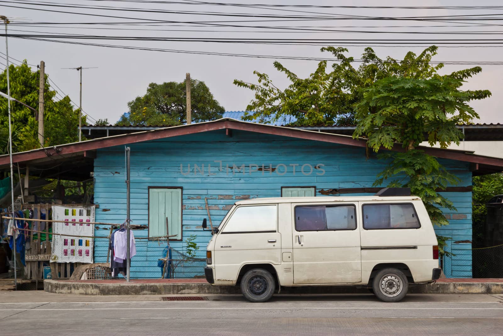 old car in front of house by wasan_gredpree