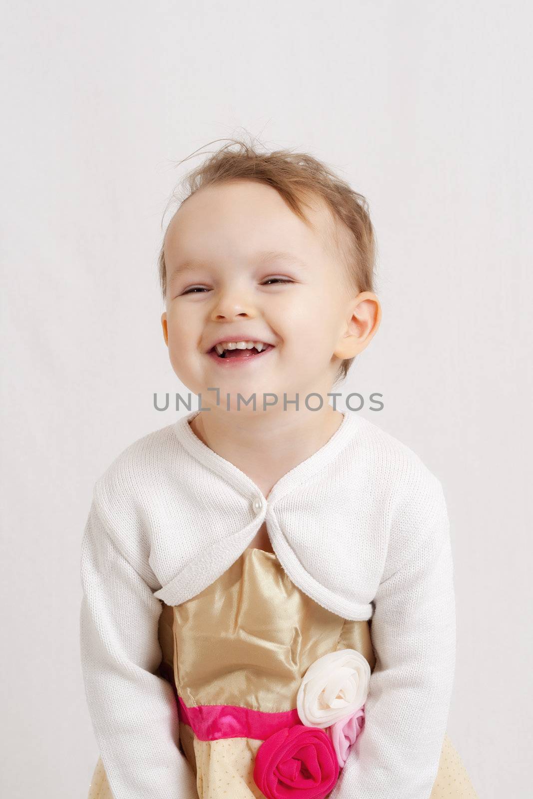 portrait of an happy smiling and laughing little blonde girl 